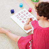 Girl Learning to Write with Magnetic Lettering Board