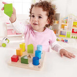 Toddler playing with shape and color sorting toy