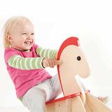 Child on wooden rocking horse
